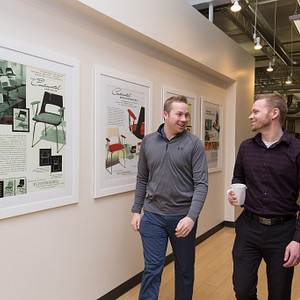 Corporate employees in hallway; employees walking through the Design hallway at KI